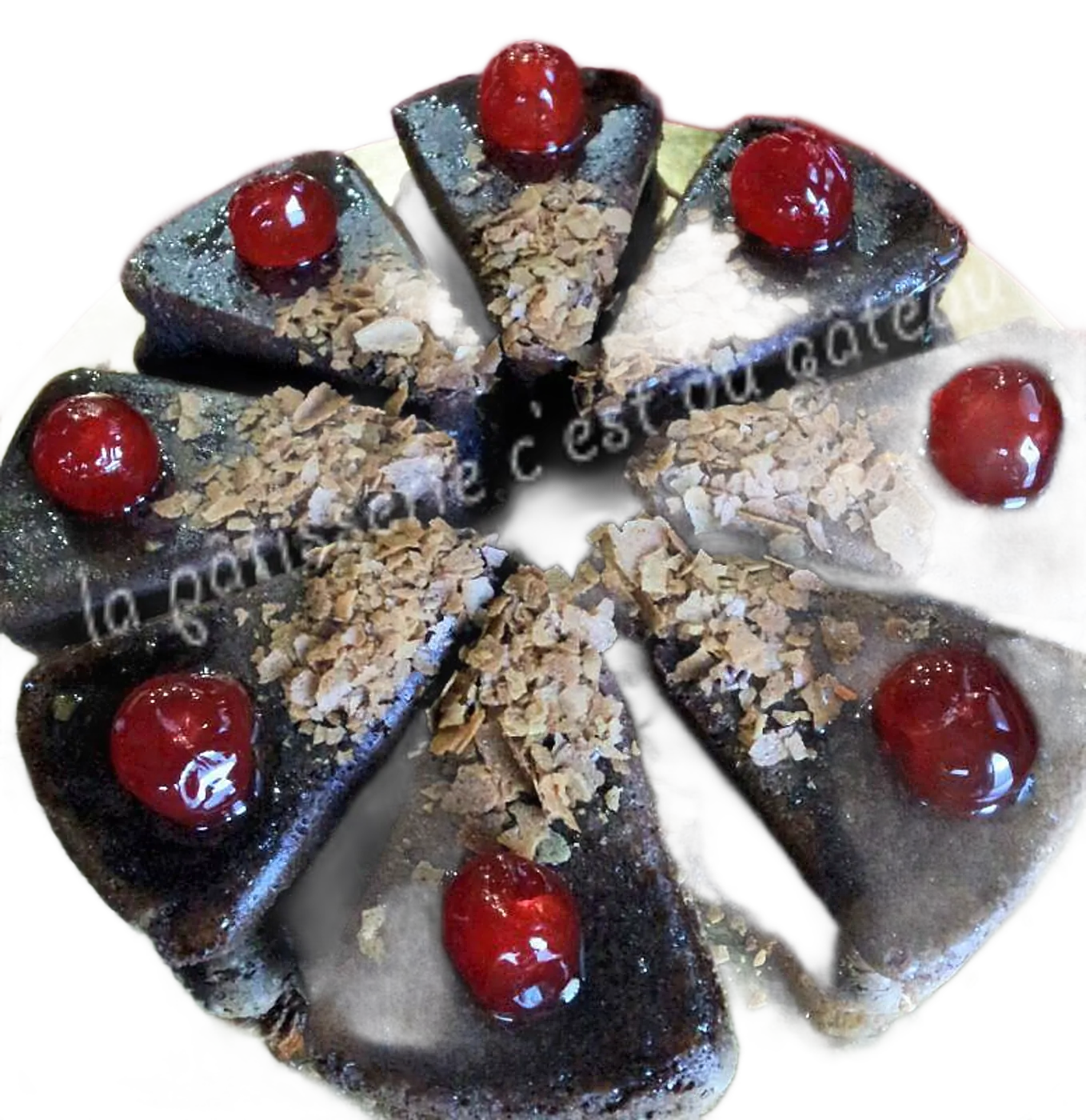 Parts de gâteau au chocolat garnies de cerises confites et d'amandes effilées.